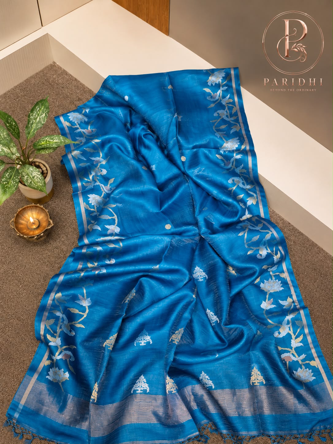 Cerulean blue tissue tassar Benarasi saree with silver lotus creeper and zari pallu
